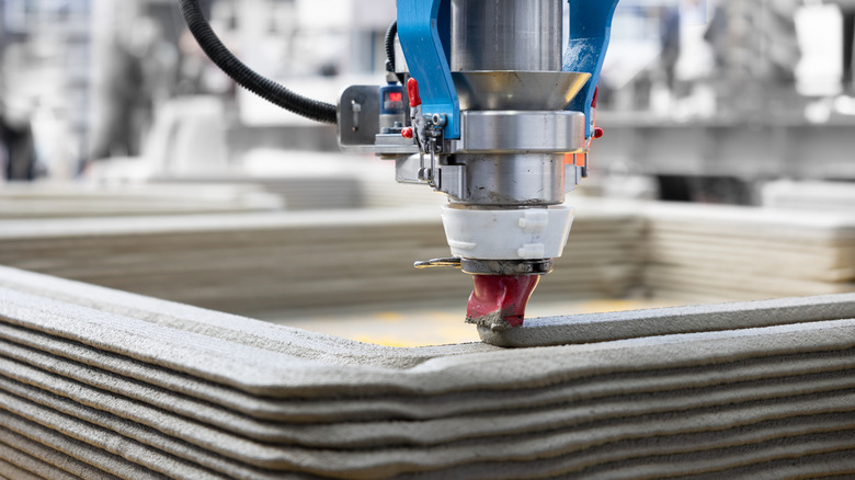 Construction 3D printer extruding cement for a structural build.