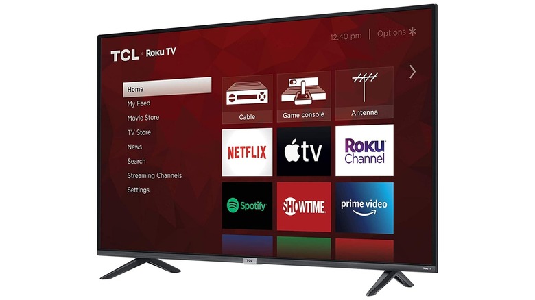 An Amazon promotional image for the TCL Class 4-Series 4K Roku TV, the TV is displaying a list column of links alongside several streaming apps