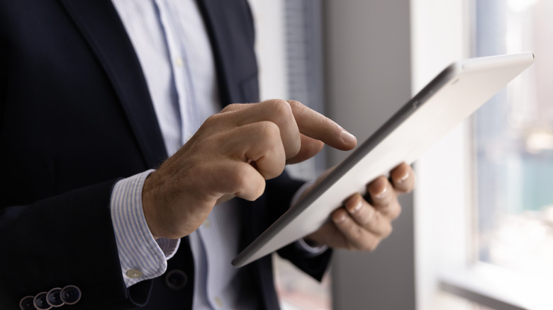 A business professional using a 5G-enabled tablet