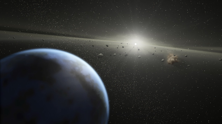 NASA artwork showing a planet in the foreground, asteroids in the middle, and the sun in the distance