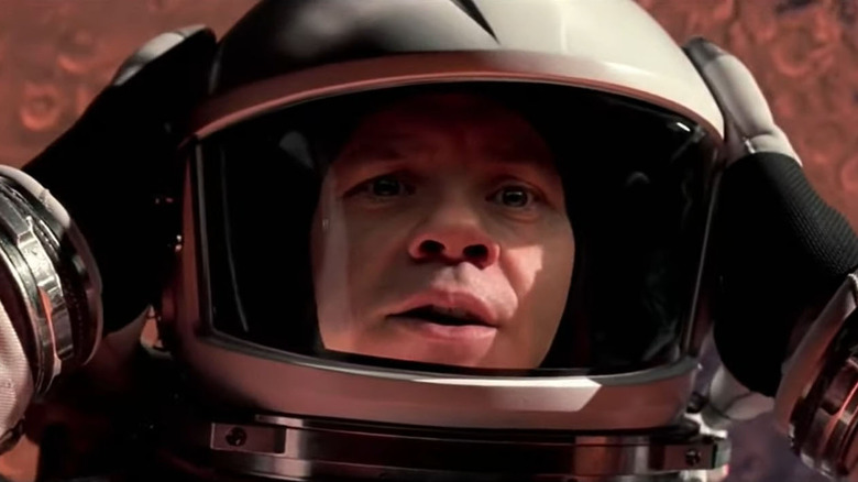 Tim Robbins' character in "Mission to Mars" preparing to remove his helmet in space