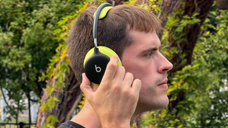 Close-up shot of a man using Beats 360 headphones