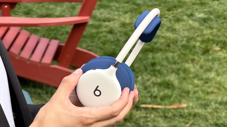 A person holding the new Beats 360 headphones