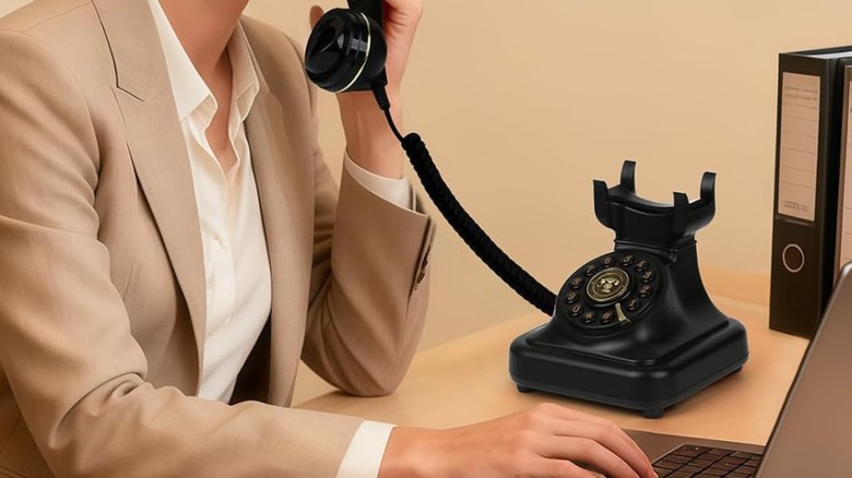 A person talking on a Sangyn Bluetooth Landline Telephone.