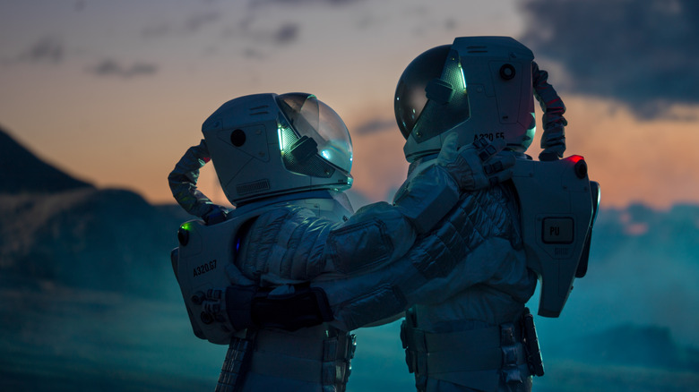 Two astronauts hugging