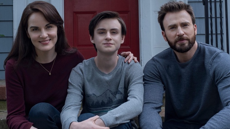 Laurie, Jacob, and Andy Barber smiling together on their front porch