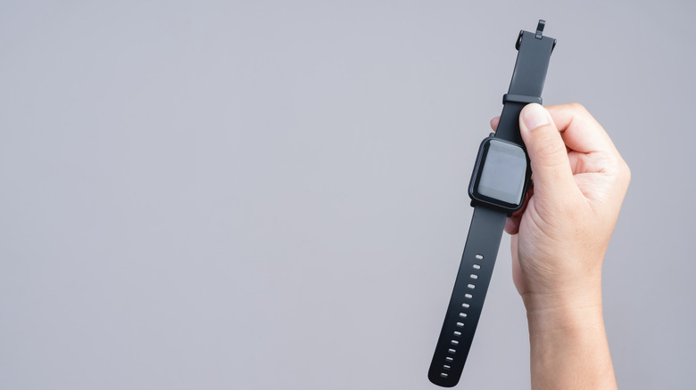 Hand holding up a smartwatch