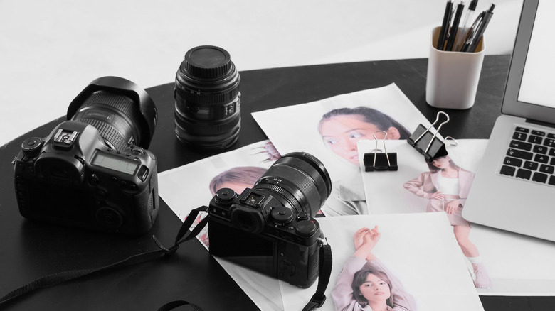 Mirrorless cameras arranged on a desk with camera accessories.