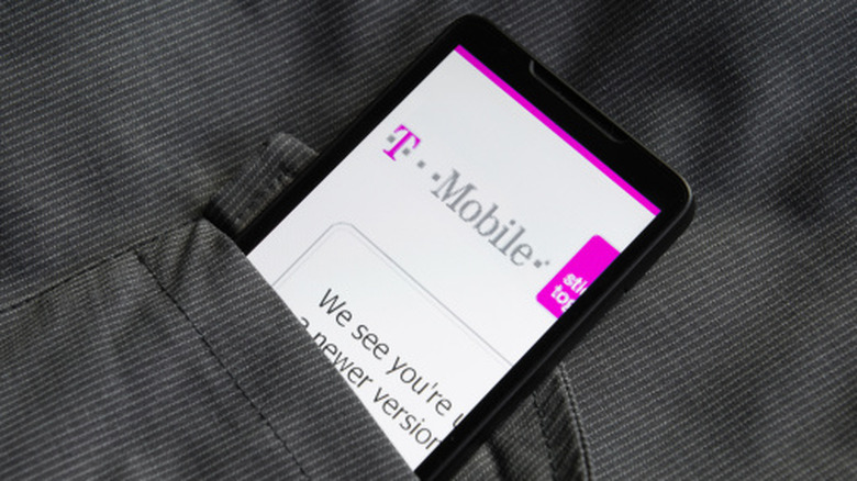 Smartphone showing the T-Mobile website while tucked inside a pocket.