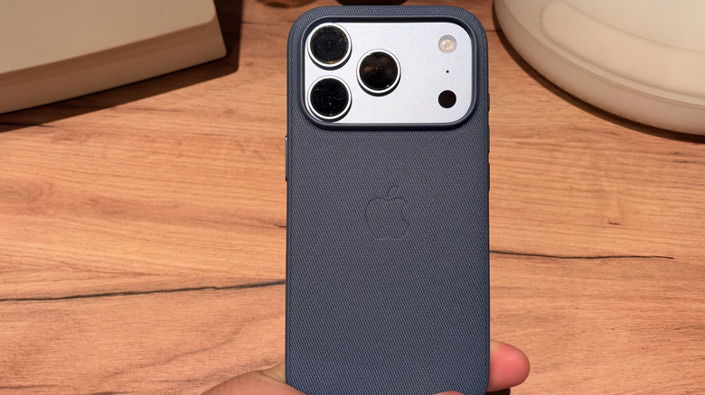 Person holding iPhone 18 Pro in TechWoven case.