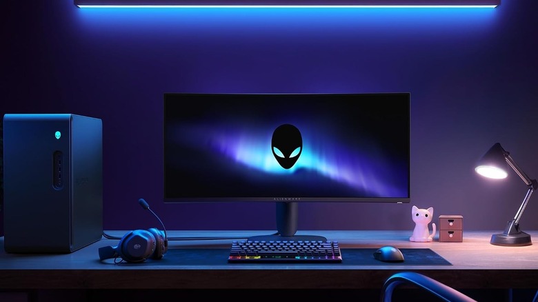 The Dell Alienware AW3425DWM monitor on a computer desk with peripherals around