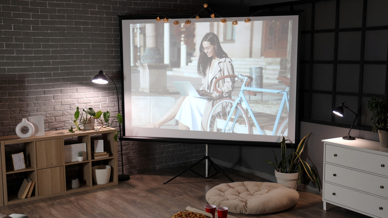 A movie being projected onto a screen in a home theater setup