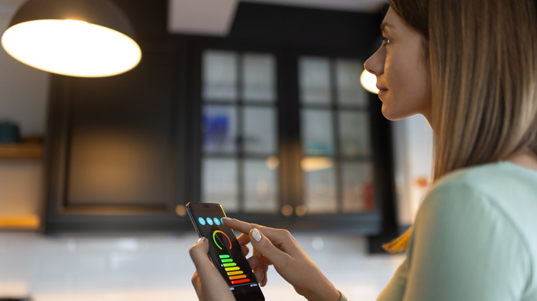 person turning off smart light on phone