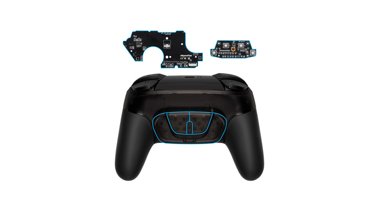 Back button attachment highlighted on rear of controller with circuit boards