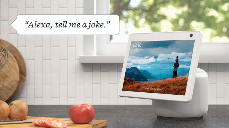 An Alexa device in a white, sunlit kitchen with an unseen person asking it to tell a joke