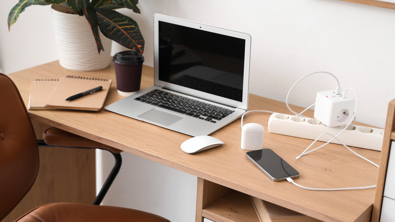 A desk with electronics sitting on top of it