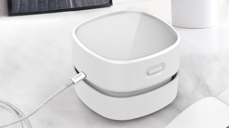 A Odistar Desktop Vacuum Cleaner on a white surface