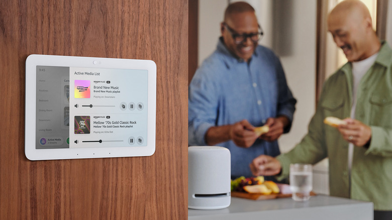 Echo Hub on wall of home with people in next room