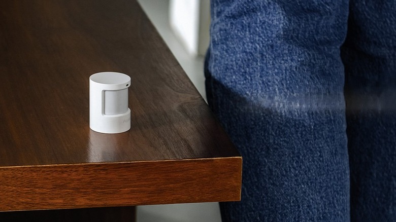 Aqara Motion and Light Sensor P2 sitting on edge of table
