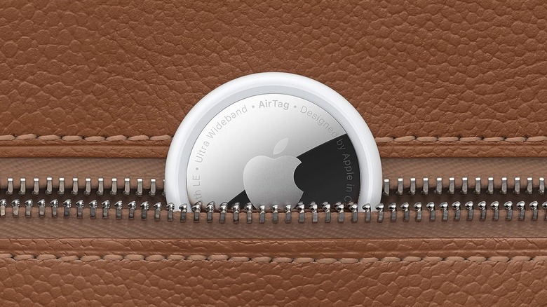 An Apple AirTag tucked halfway into a zippered pocket.