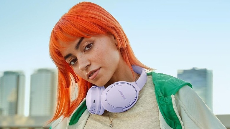 A person wearing the Bose QuietComfort Bluetooth Headphones on their neck