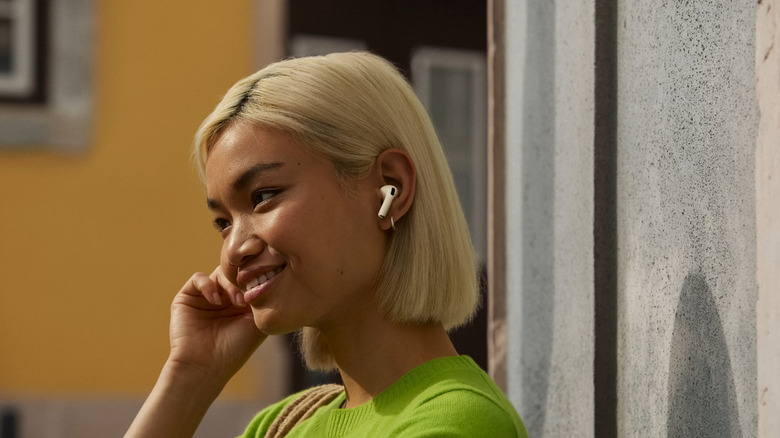 Girl in green wearing AirPods Pro 3