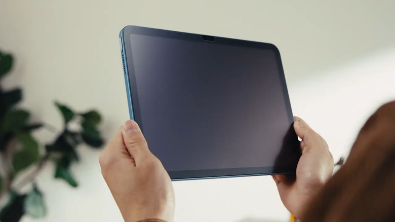 Hand holding iPad with ESR 2 Pack Paper-Feel Screen Protector