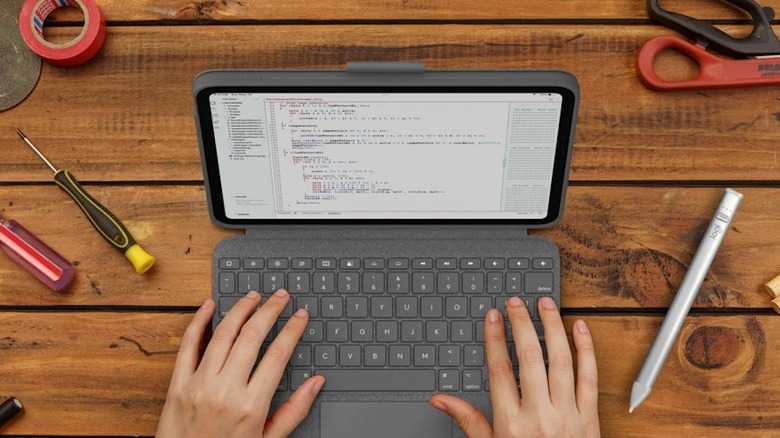 Hands on Logitech Combo Touch connected to iPad with tools around