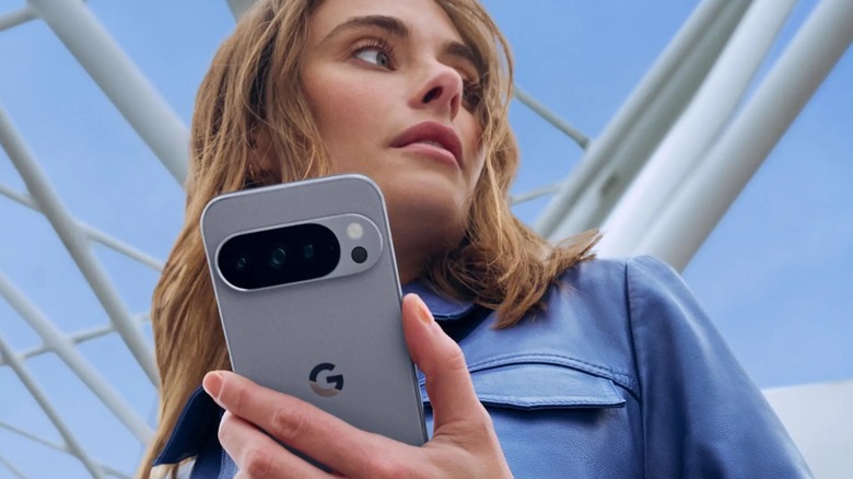 Person holding the Google Pixel 10 in her hands looking away.