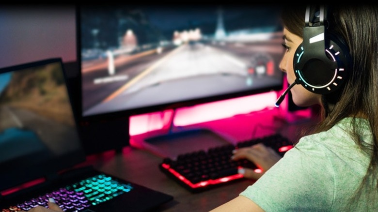 Woman playing games on AMD-powered gaming PC and laptop