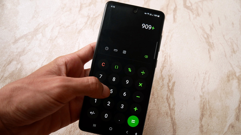 Someone using a calculator app on an Android