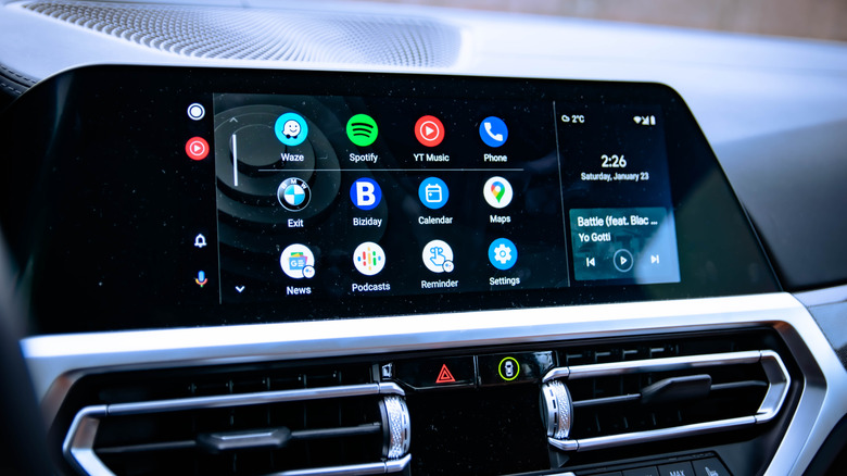 Three rows of app icons as they appear within Android Auto, the display itself is inside the dashboard of a vehicle
