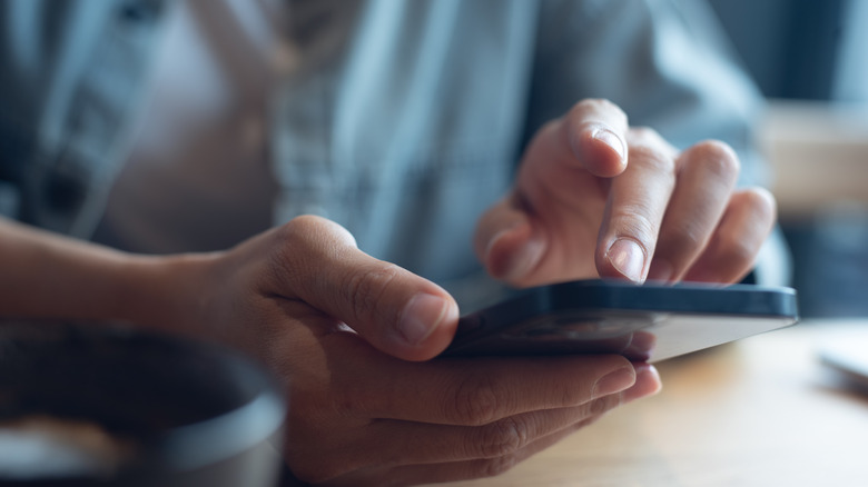 A person typing on their phone