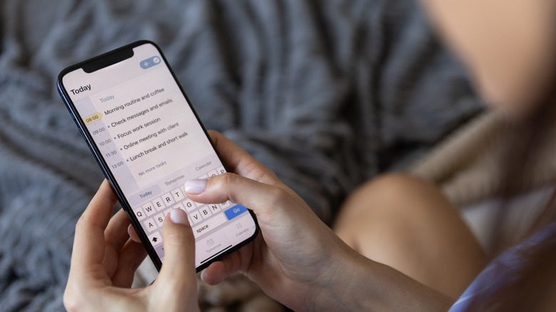 A person using their phone to record daily tasks