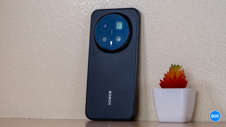 Honor Magic8 Pro phone by a wall