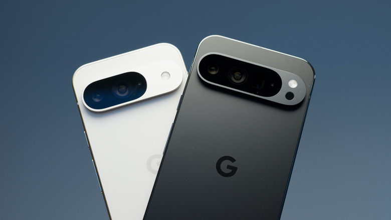 Hand holding two Google Pixel phones