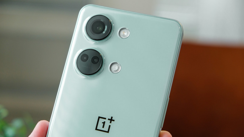 Hand holding a OnePlus phone