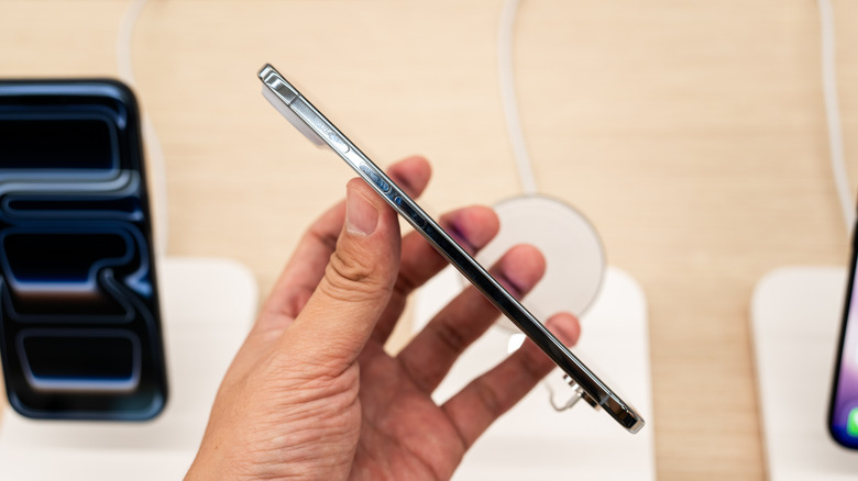 A person holding an iPhone Air sideways to show how slim it is