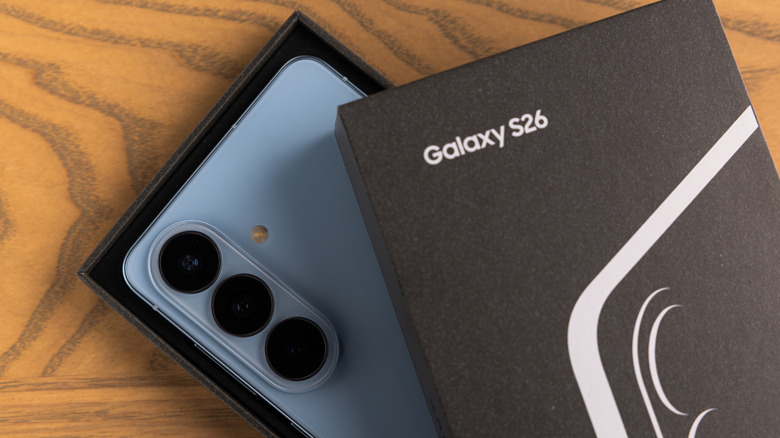 Samsung Galaxy S26 shown inside its box with the rear cameras visible.
