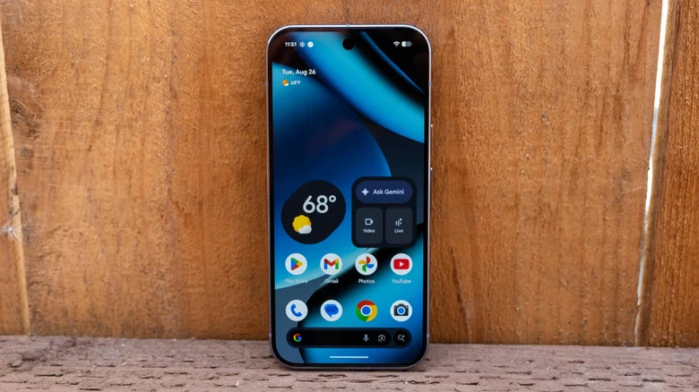 The Pixel 10 Pro placed on a fence with the screen unlocked.