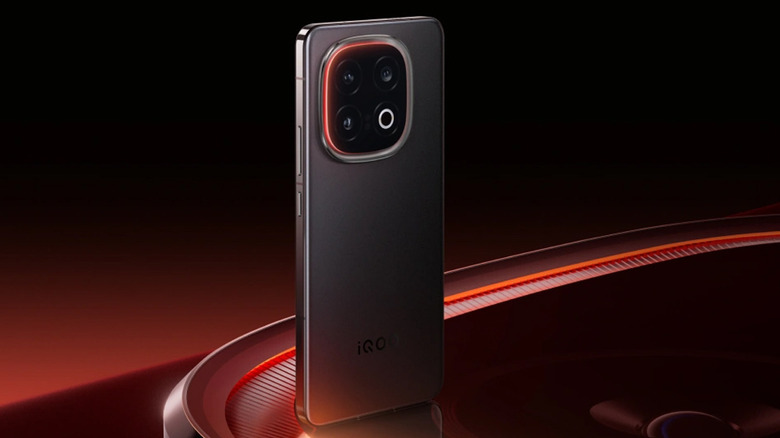 iQOO 13 back profile showcasing its camera array in its black colorway on a black and red gradient background.