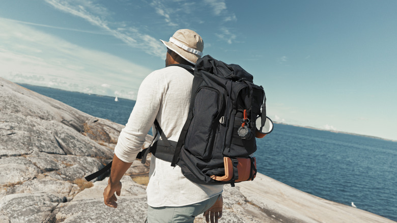 Person wearing large backpack while hiking