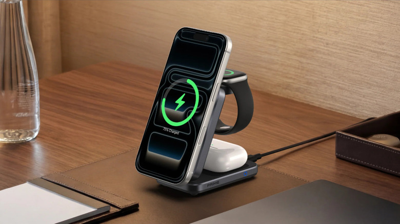 A Anker Prime Foldable Wireless Charging Station charging an iPhone, AirPods, and an Apple Watch simultaneously on a table