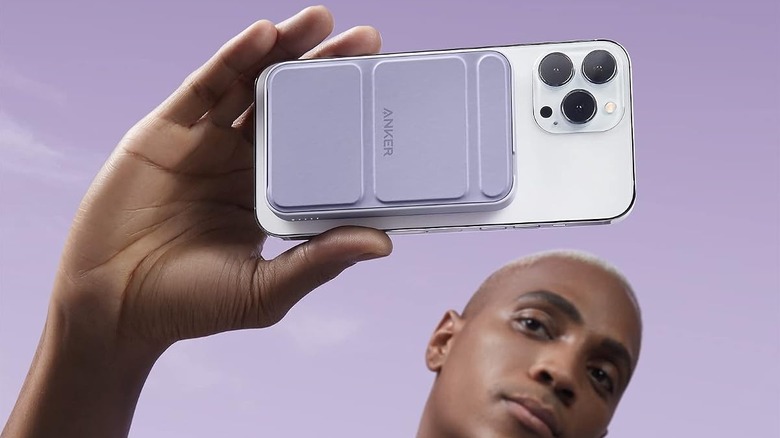 close-up anker maggo powerbank on the back of someone's phone as they snap a selfie