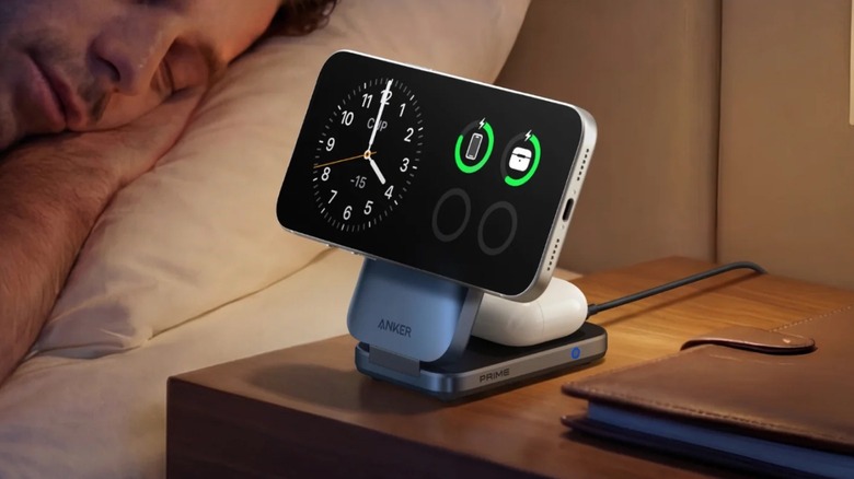 A man sleeping next to a 3-in-1 wireless charger stand