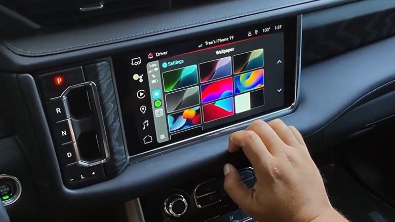 car driver choosing a new apple carplay wallpaper