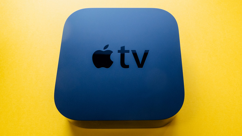 Apple TV 4K against yellow backdrop