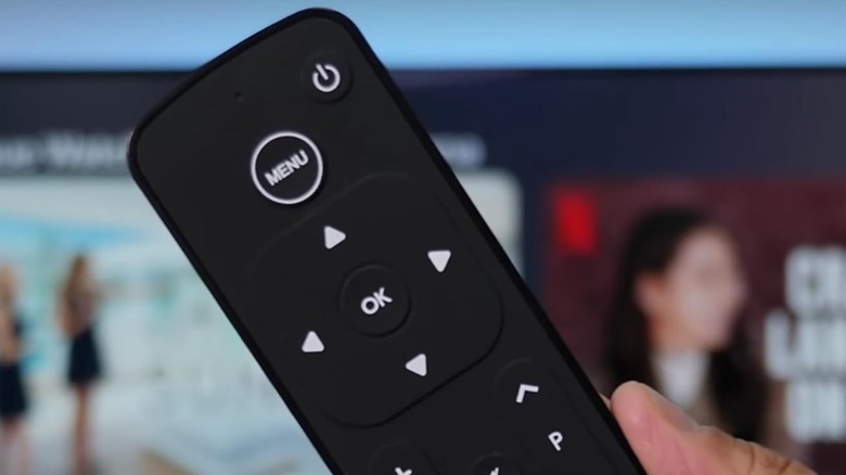 A hand holding a Function101 remote