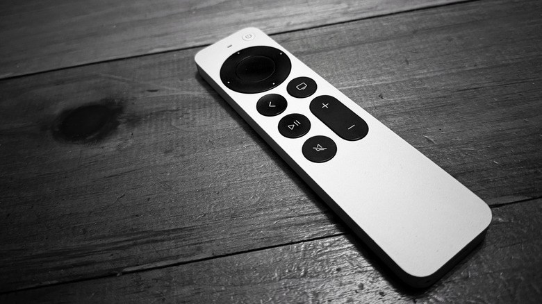 Apple TV remote control on a wooden background