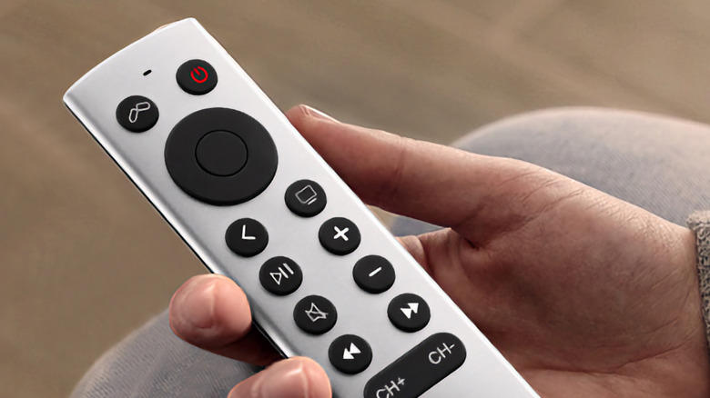 A hand holding a Loutoc remote